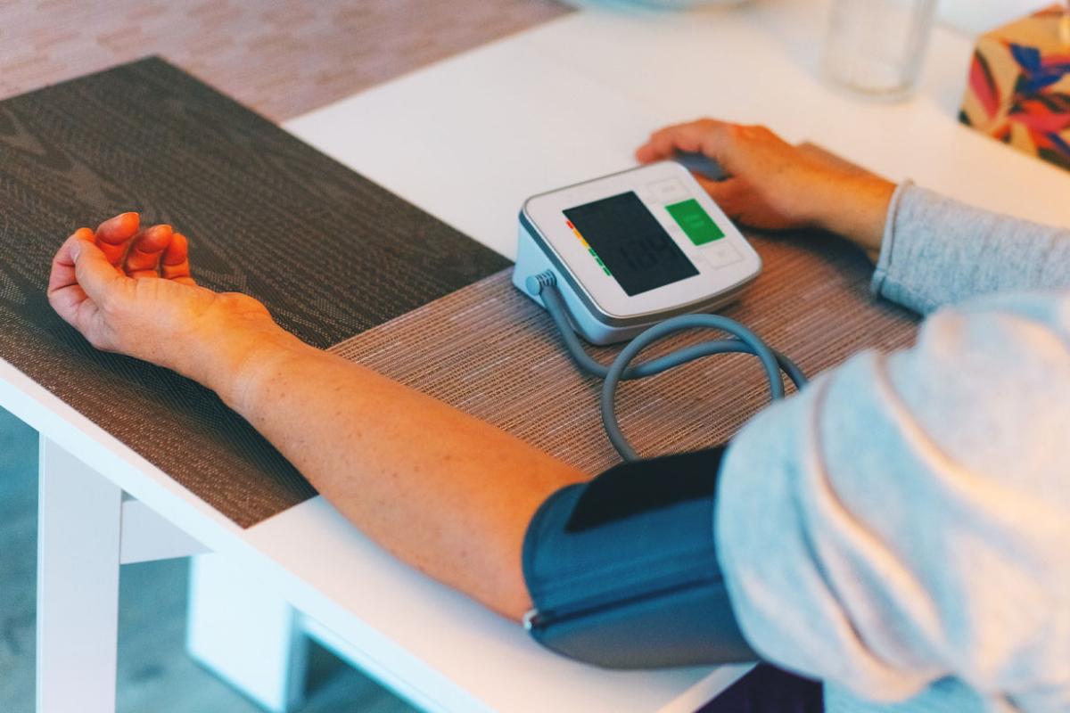 Person checks blood pressure at home