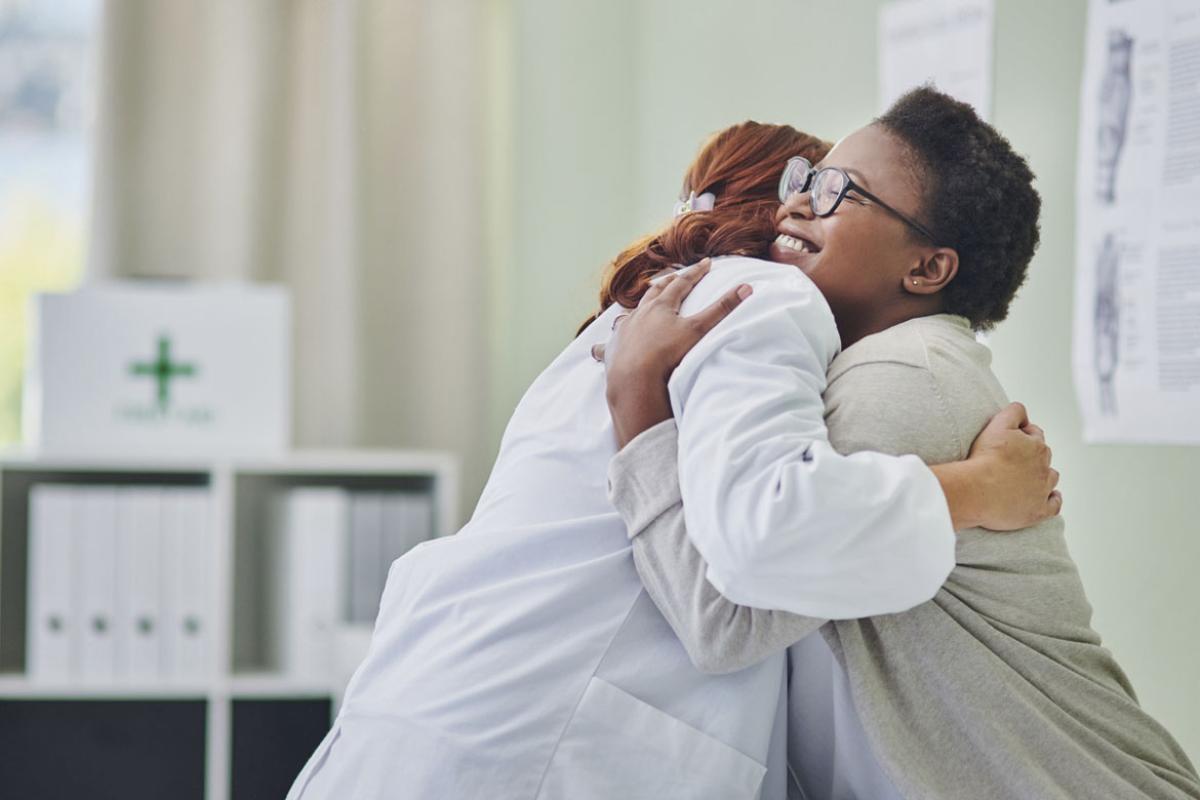 Patient hugs doctor during a consultation 