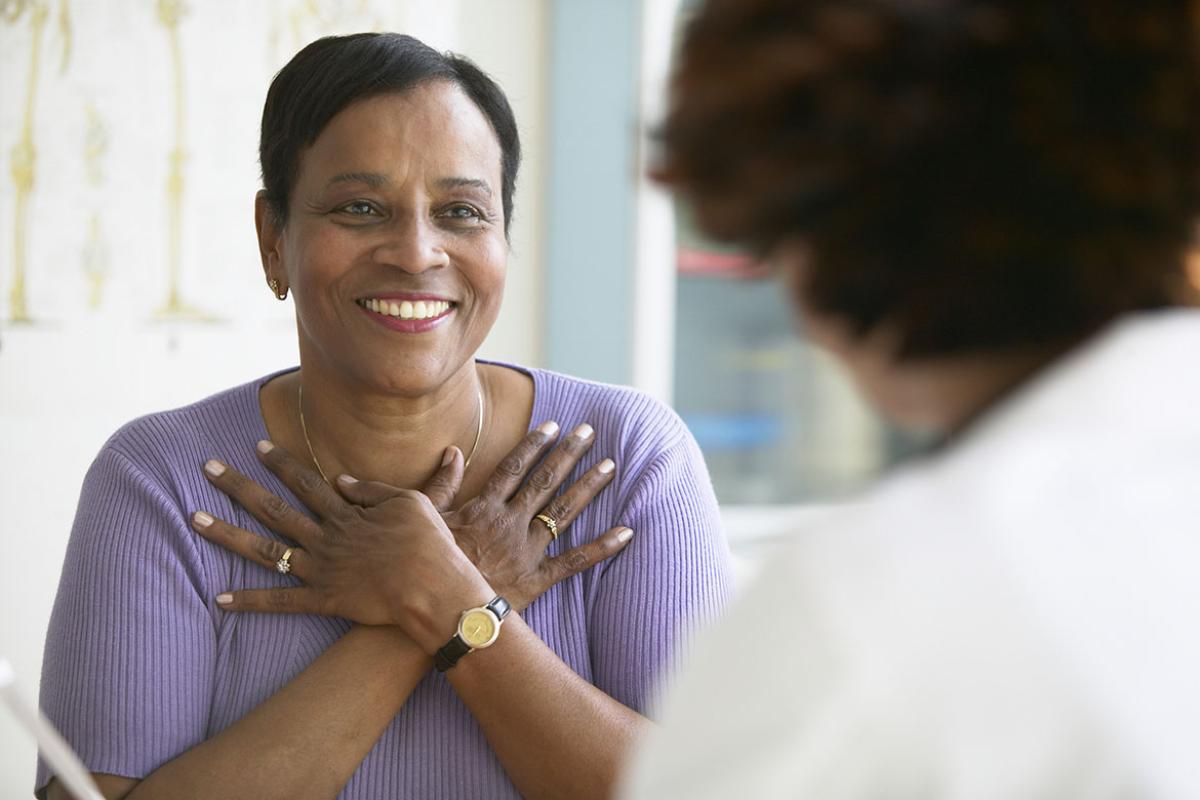 Smiling patient with hands crossed on chest